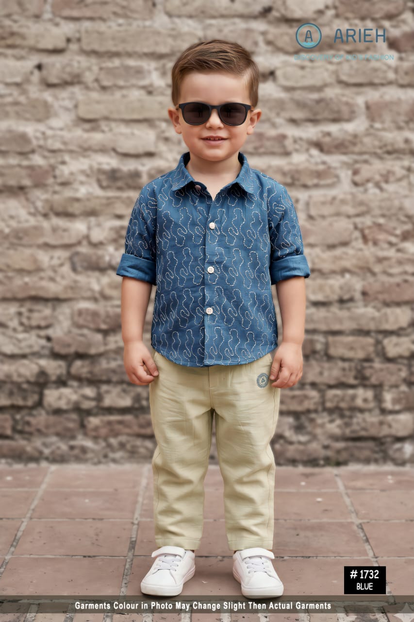 Boy wearing an Arieh printed muslin cotton shirt with cream trousers and sunglasses